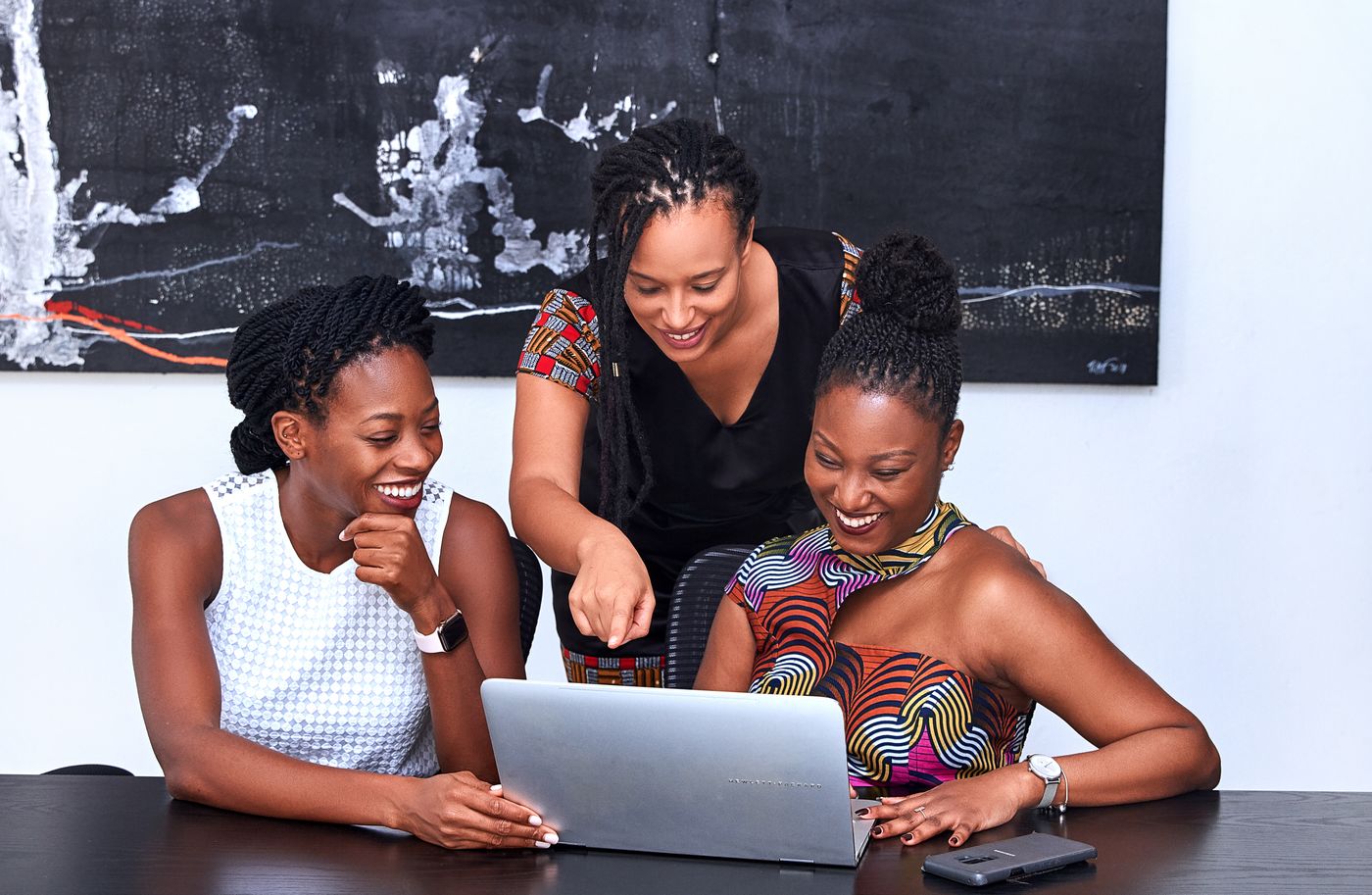 African creatives collaborating around a laptop